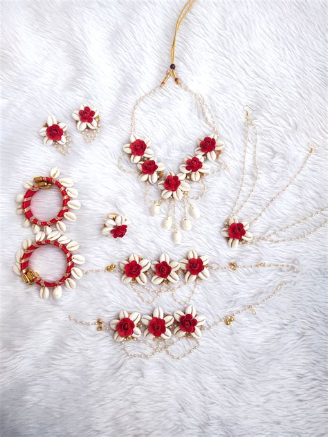 Shell jewellery for Haldi and Baby showers with red flowers ...
