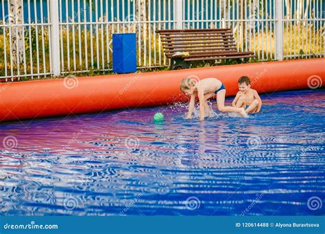 Two Funny Boys Play Water Football in an Inflatable Outdoor Pool Stock Photo - Image of active ...