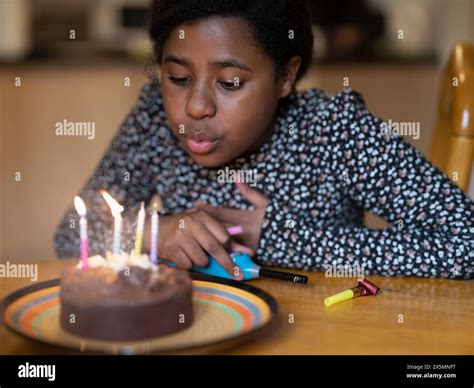 Blowing candles out on her birthday cake hi-res stock photography and ...