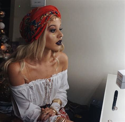 a woman with makeup on her face sitting in front of a computer
