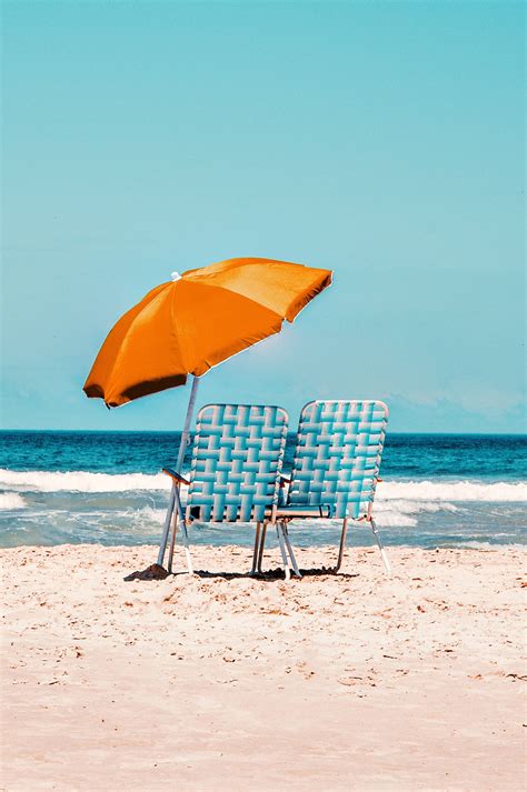 Download 4k Ultra Hd Beach Chairs Umbrella Wallpaper | Wallpapers.com