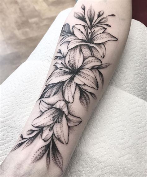 Unveiling the Profound Symbolism of Lily Flower Tattoos: A Journey Through Beauty and Meaning