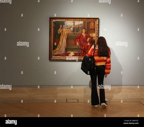 An art enthusiast looks at the oil on canvas painting The Gilded Cage ...