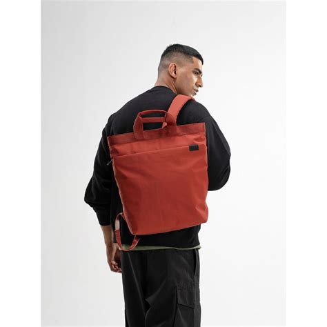 Buy DailyObjects Unisex Solid Pivot Carrypack Backpack - Orange (M) Online