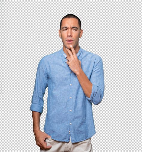 Concentrated young man making a gesture of distrust | Premium PSD