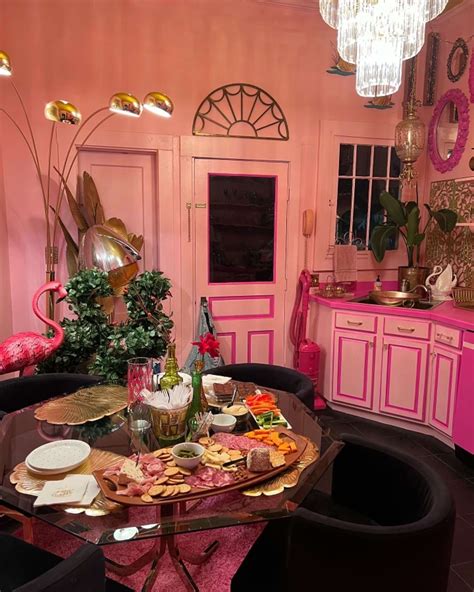 A retro dining room with pink walls and black chairs by Jenn Stookey in ...