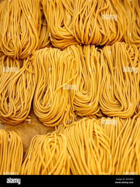 Closeup on strops of dry egg noodle nests texture Stock Photo - Alamy