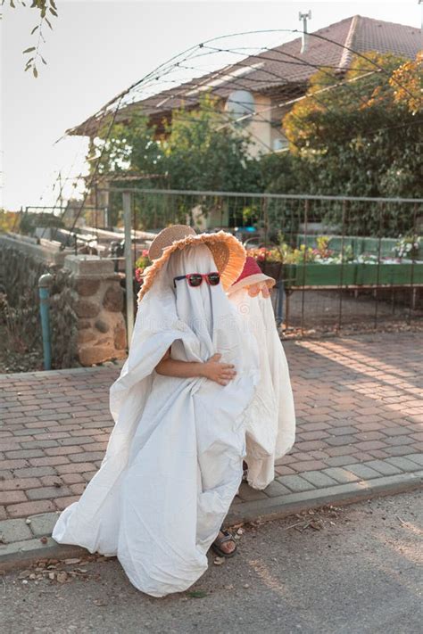 Trendy Sheet Ghosts Costumes on Little Kids Standing on a Suburbs ...