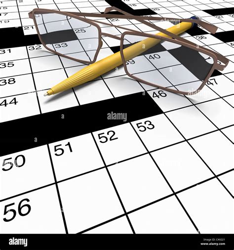 Extreme close up of crossword puzzle with yellow pen and spectacles in ...