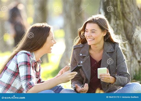 Two Friends Talking Holding Their Smart Phones Stock Image - Image of ...
