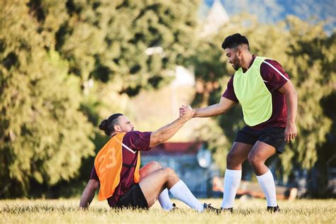 Premium Photo | Rugby teamwork and a sports man helping a friend while ...