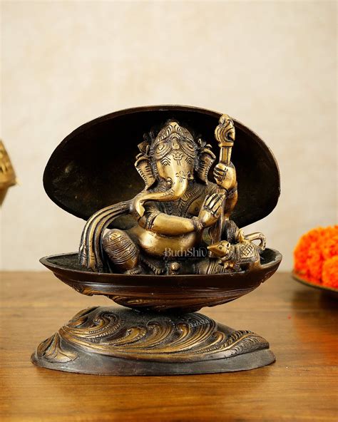 Buy Brass Lord Ganesha Playing Veena Inside Shell – 7” - Budhshiv.com