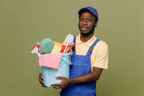 Strict holding bucket of cleaning tools young africanamerican cleaner ...
