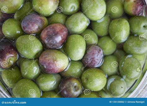 Green olives in brine stock photo. Image of delicious - 135120062
