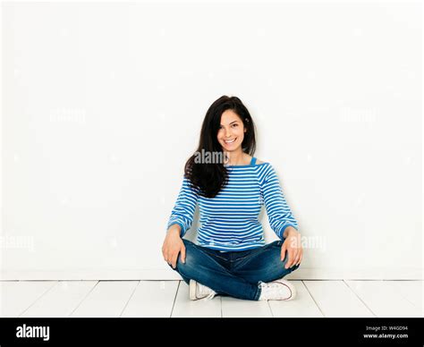 Beautiful young woman with black hair and blue white striped sweater ...