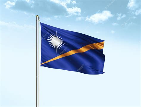 Premium Photo | Marshall islands national flag waving in blue sky with ...