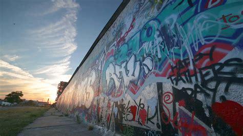 Download Berlin Wall Graffiti During Sunset Wallpaper | Wallpapers.com