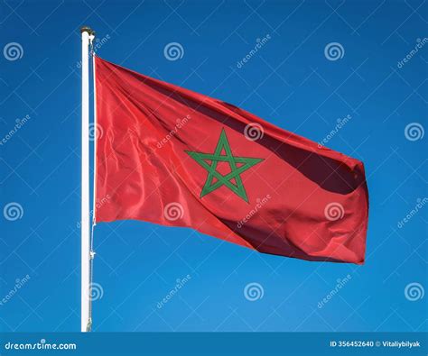 Moroccan Flag, Red with a Green Pentagram, Fluttering Vividly Against a Deep Blue Sky Stock ...