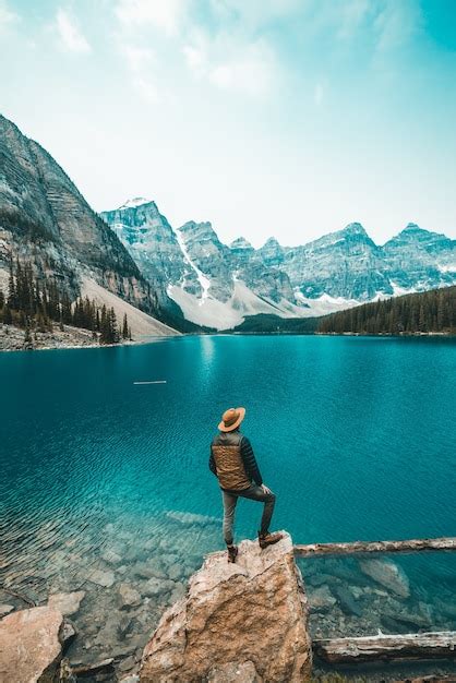 Man standing on rock near lake | Free Photo