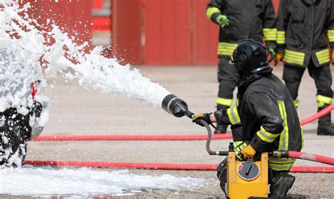 Firefighter Fighting Fire With Hose