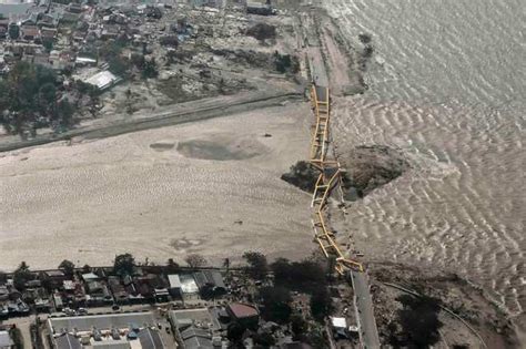 A man walks on a street after an earthquake and tsunami hit the area in ...