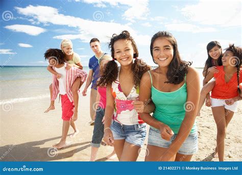 Group Of Teenagers Walking Along Beach Stock Image - Image: 21402271