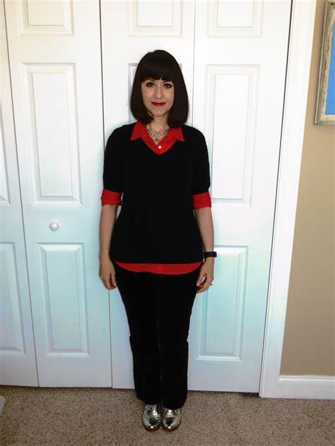 Orange collared shirt under black short sleeved sweater, black pants ...