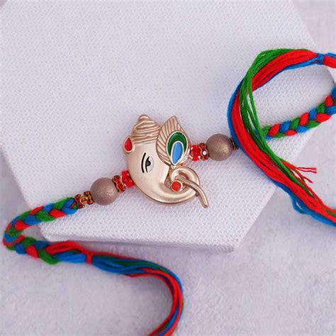 Send Ganesha Rakhi with Tie and Cufflink Set Online | Rakhibazaar.com