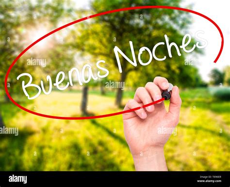 Man Hand writing Buenas Noches (Good Night In Spanish) with black marker on visual screen Stock ...