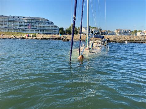 Sailboat takes beating at Madison's West Wharf during storm