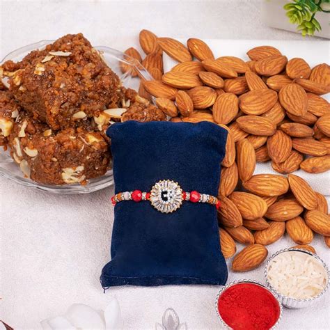Send Pious Silver Om Rakhi with Sweets Combo Online - RKH23-110861 ...
