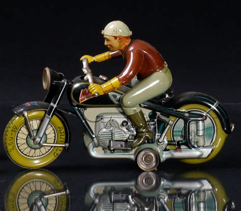 Bonhams Cars : An Arnold wind-up tin motorycle lithographic toy,