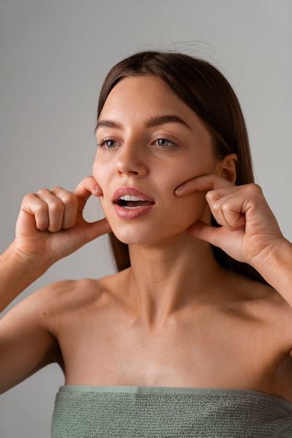 Portrait of woman trying facial yoga massage to stay young | Free Photo
