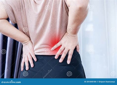 Woman with Lower Back Pain, Muscle Strain, and Spasms Due To Prolonged ...