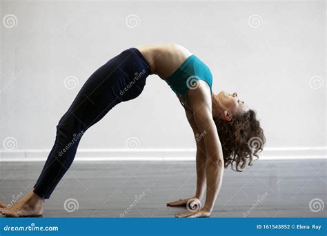 Woman in Wheel Yoga Pose stock photo. Image of beauty - 161543852