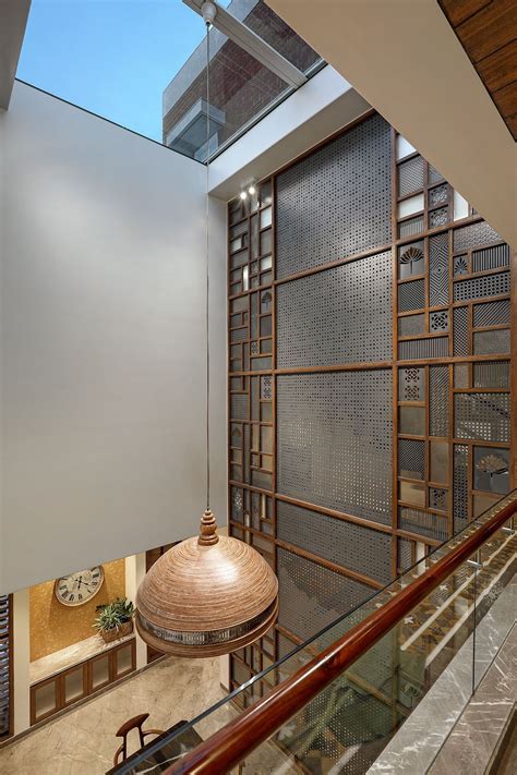 This Vadodara bungalow embraces a grey colour palette with jali work ...