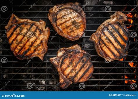 Tongs Flipping Seasoned Pork Chops on Flaming Grill Stock Image - Image ...