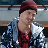 a man wearing a red and black beanie