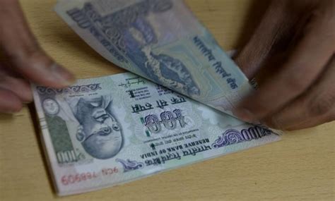 Rupee predicted to trade at 68.22 per dollar in a year; will hit a ...