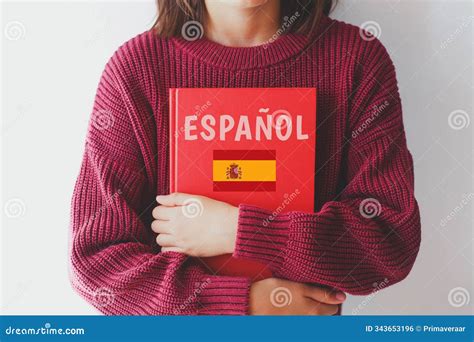 Girl Schoolgirl in Burgundy Sweater Holds Red Spanish Language Textbook ...