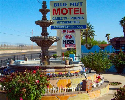 Front fountain and signage at Blue Mist Motel highlighting amenities ...