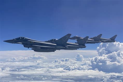 Royal Air Force ground crew preparing an RAF Typhoon fighter jet. It is night-time and the team are