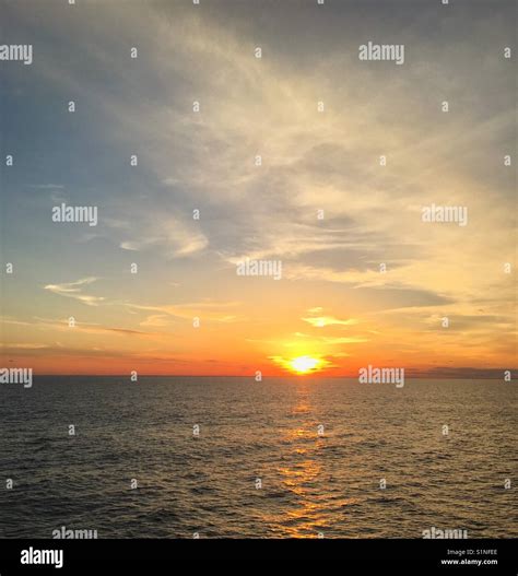 The sun rising over the Atlantic Ocean Stock Photo - Alamy
