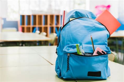 Blue schoolchild backpack on table | Free Photo