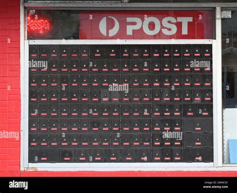 Dirty and faded Australia Post PO boxes outside a shop in the suburbs ...