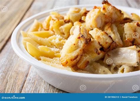 Bowl of Chicken Penne Alfredo Stock Photo - Image of placemat, drink ...