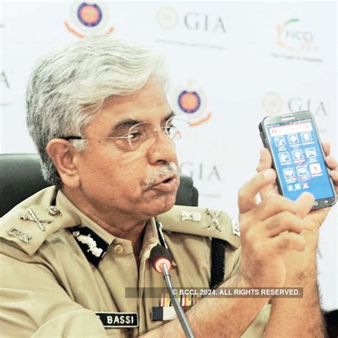 BS Bassi, Commissioner of Police, showing the Police App during a ...