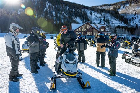 Rider riding up a snowy mountain on the 2027 Ski-Doo Summit