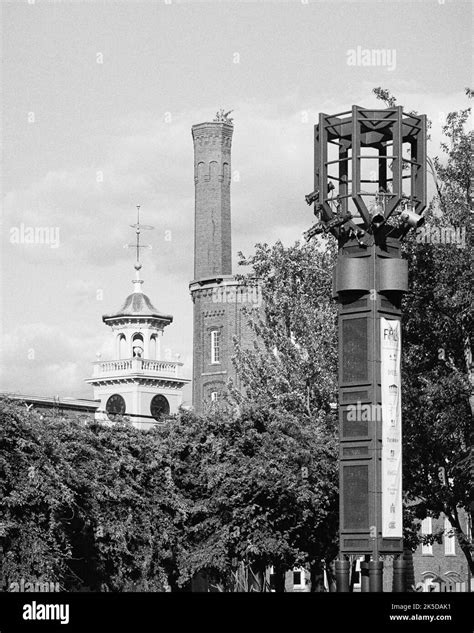 A smoke stack from a closed cotten mills rise above the trees in historic Lowell, Massachusetts ...
