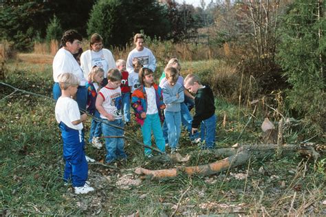 Group of students/teachers looking at beaver-chewing at Muscatatuck ...